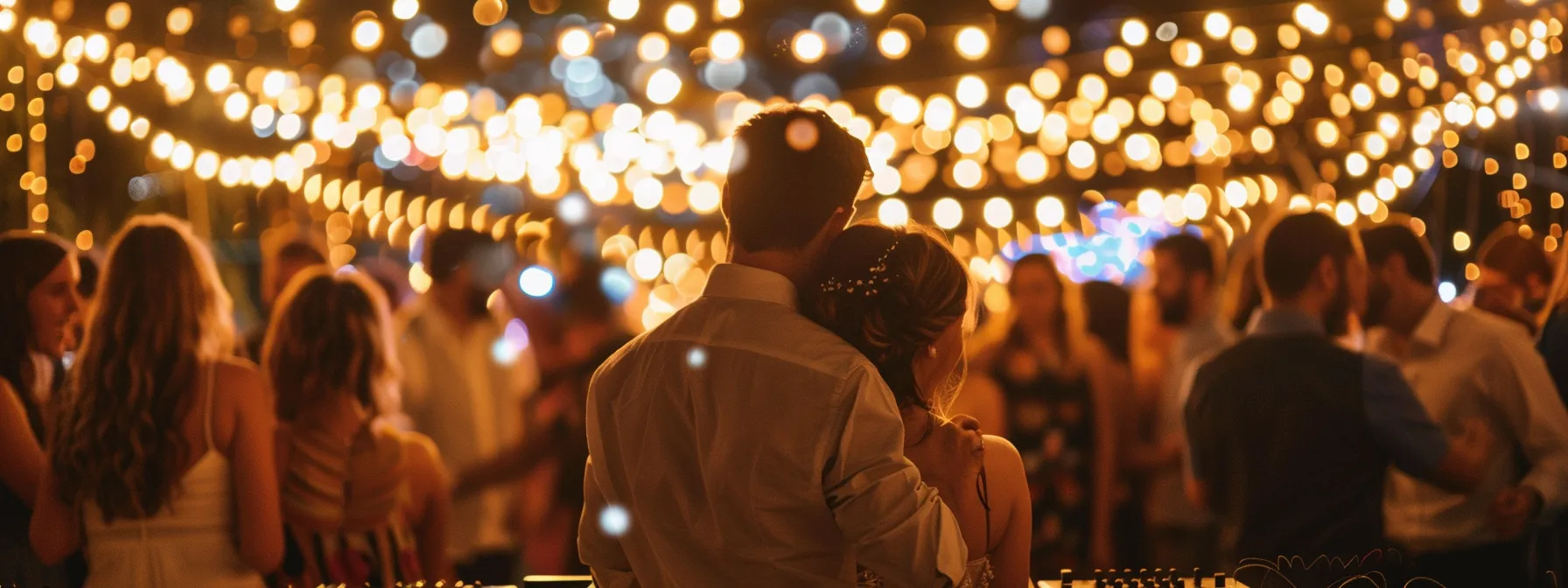 a captivating scene of a vibrant dj booth at a lively wedding reception in vancouver, adorned with string lights and surrounded by joyful guests dancing under a warm, golden glow.