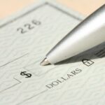 Pen poised over a check, ready to write