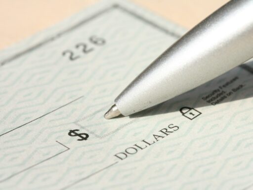Pen poised over a check, ready to write