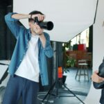 Photographer taking a picture of a model in studio