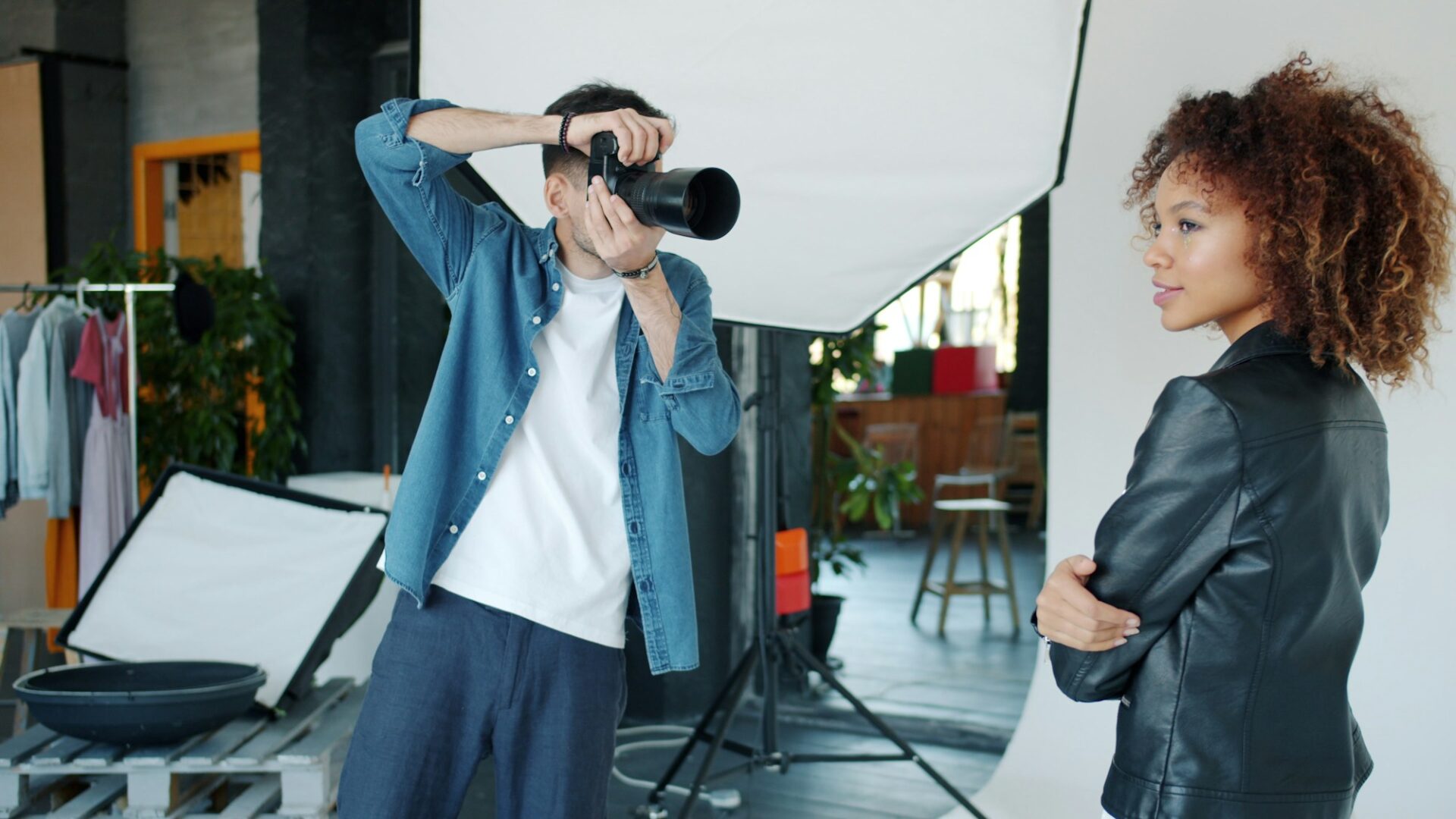 Photographer taking a picture of a model in studio