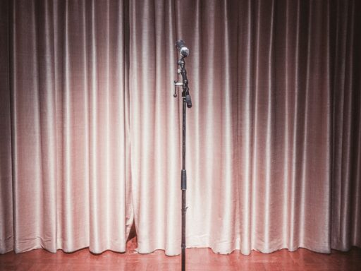 A microphone on a stand in front of a curtain