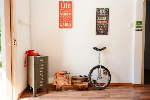 A unicycle leaning against a wall