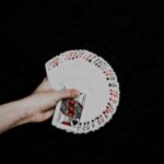 A hand holding a deck of playing cards