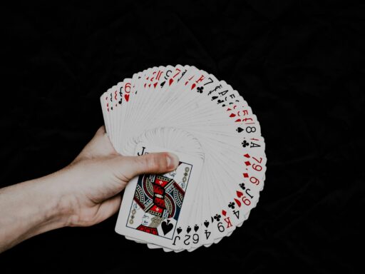 A hand holding a deck of playing cards