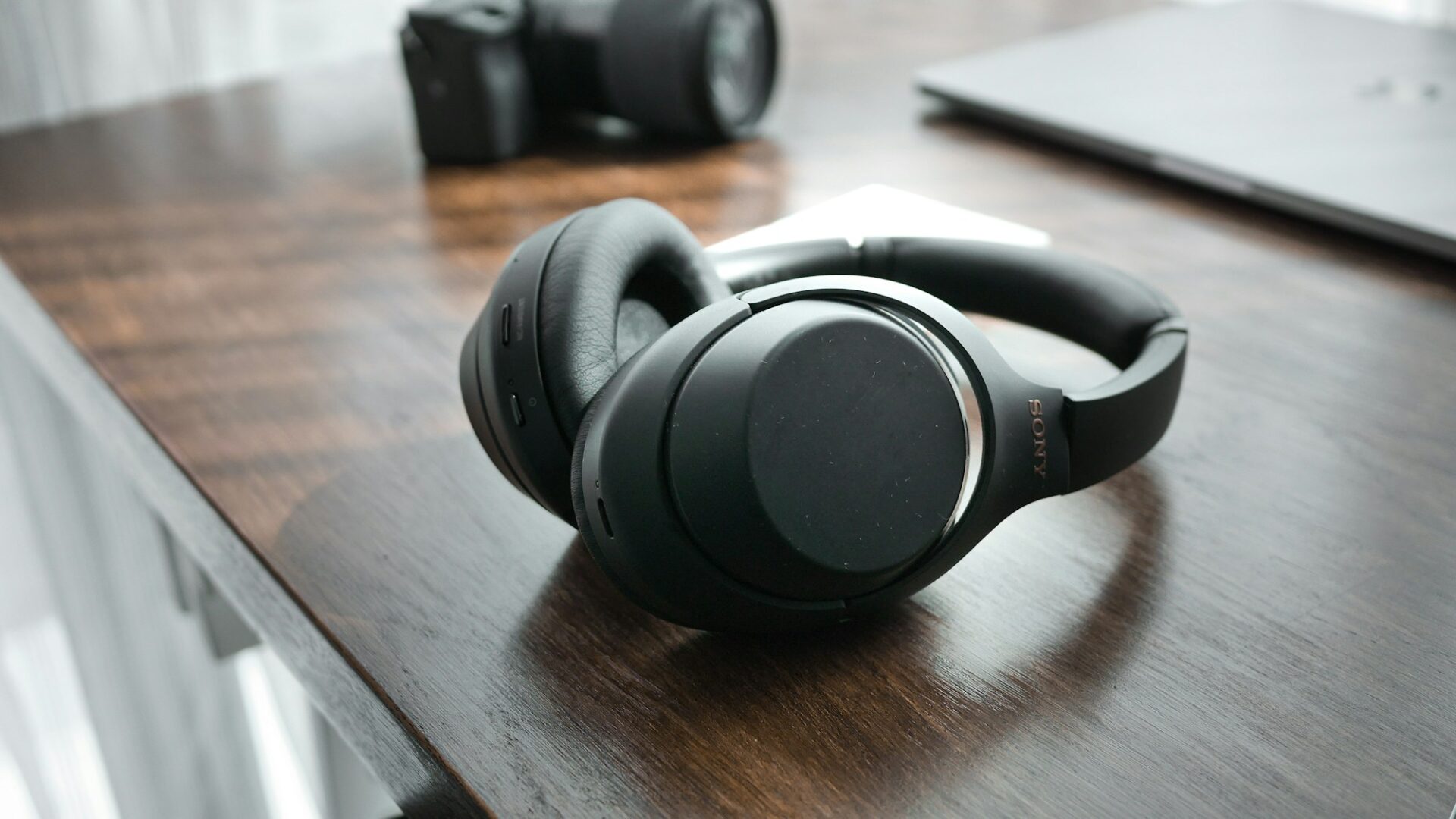 A pair of headphones on a wooden table