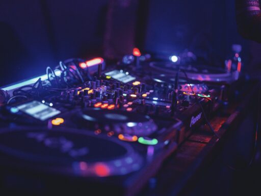A black and blue audio mixer under colored lights