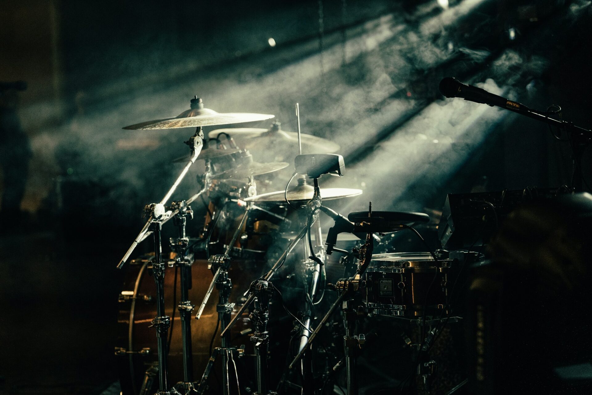 A drum set lit by warm stage lighting