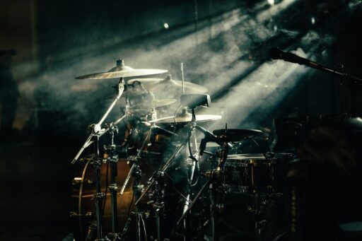 A drum set lit by warm stage lighting