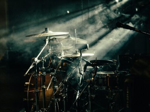 A drum set lit by warm stage lighting