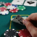 A hand holding a fan of playing cards