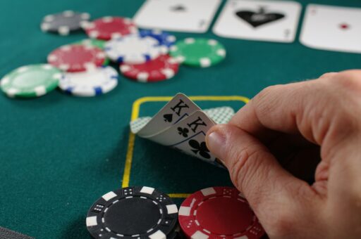 A hand holding a fan of playing cards