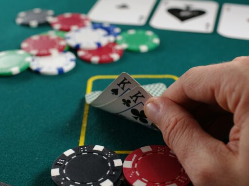A hand holding a fan of playing cards