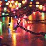 Coloured string lights glowing on a wooden floor.
