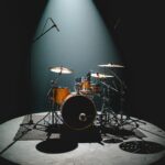 An empty drum kit set up on stage, ready for a band
