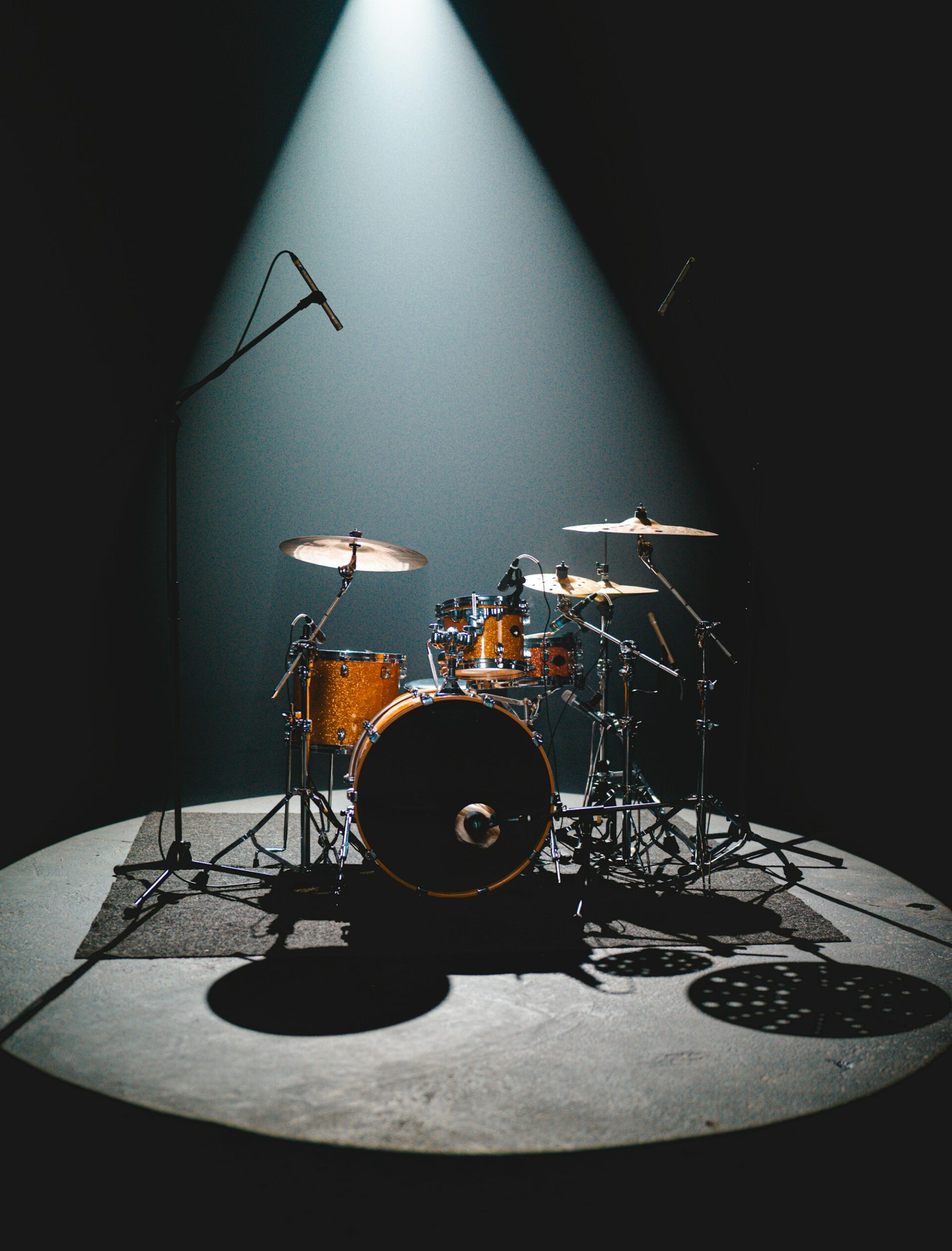 An empty drum kit set up on stage, ready for a band