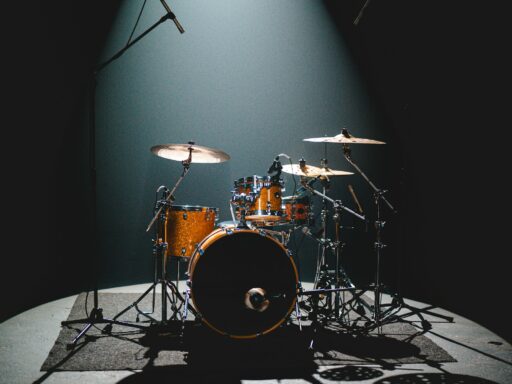 An empty drum kit set up on stage, ready for a band