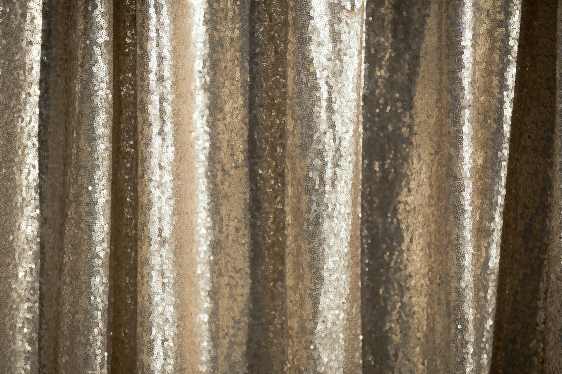 A gold sequin backdrop, the kind used behind a photo booth