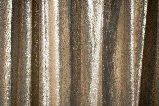 A gold sequin backdrop, the kind used behind a photo booth