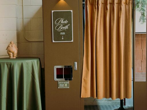 A vintage photo booth with a tan curtain